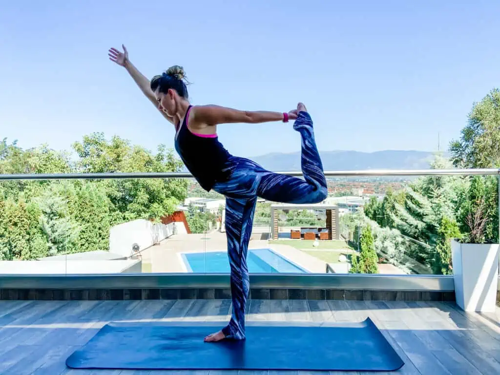 woman doing dancer pose balance exercises to improve body awareness
