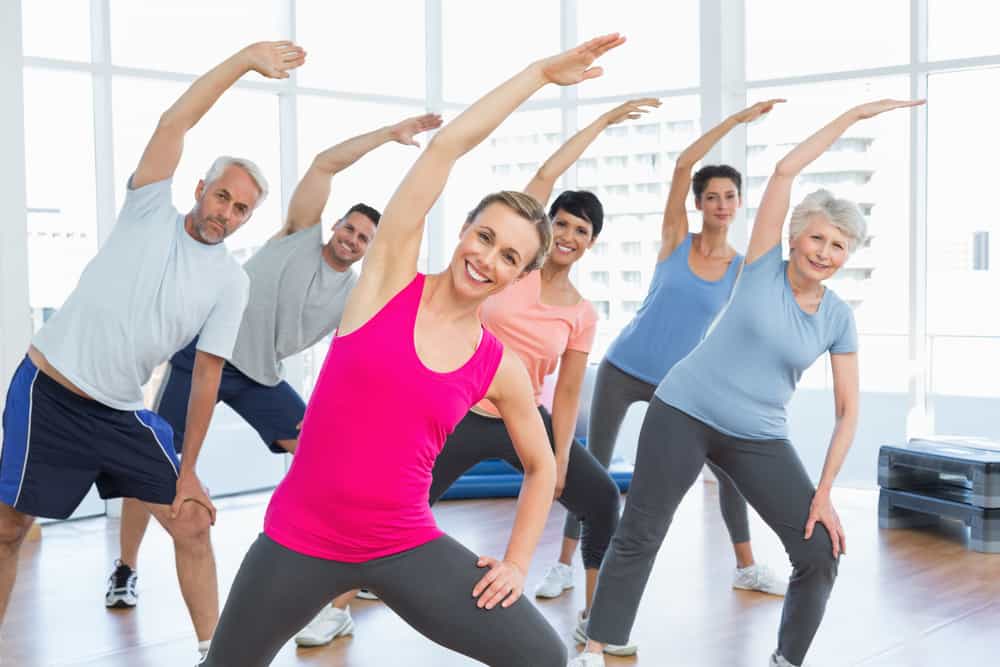 people in a group fitness class a decorative image in an article about body awareness exercises