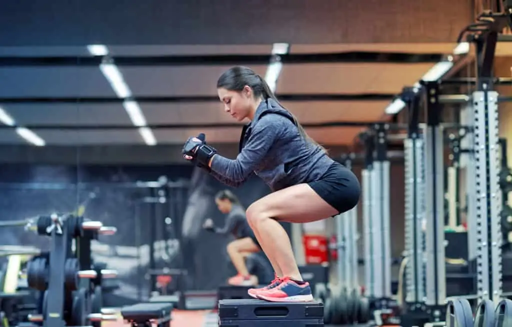 Fitness Sport Exercising And People Concept Woman Doing Squats On Platform In Gym Woman Doing Squats On Platform In Gym