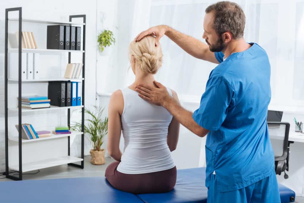 physical therapist evaluating a patient