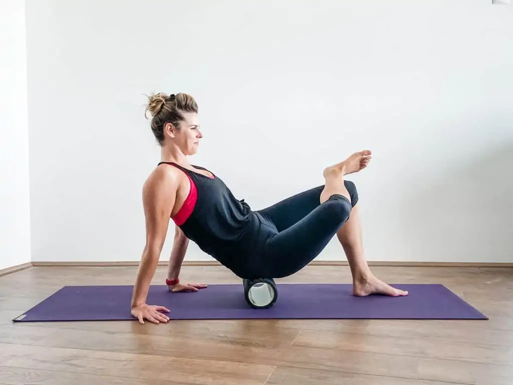 woman using a foam roller for glutes