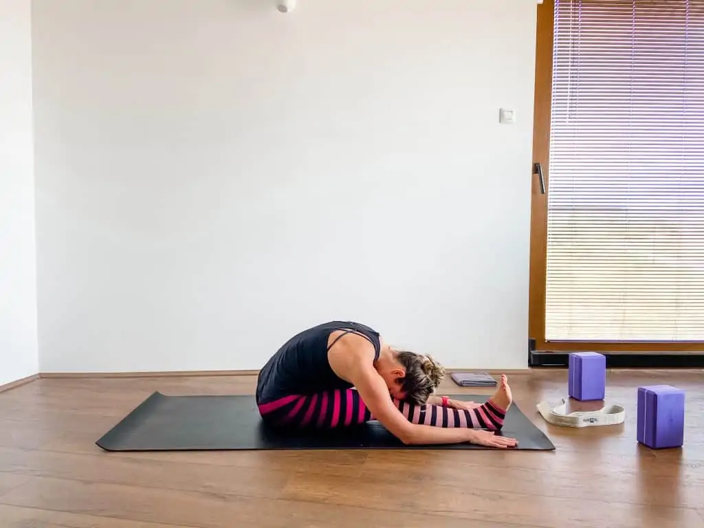 seated hamstring stretch in an article about stretching vs. yoga