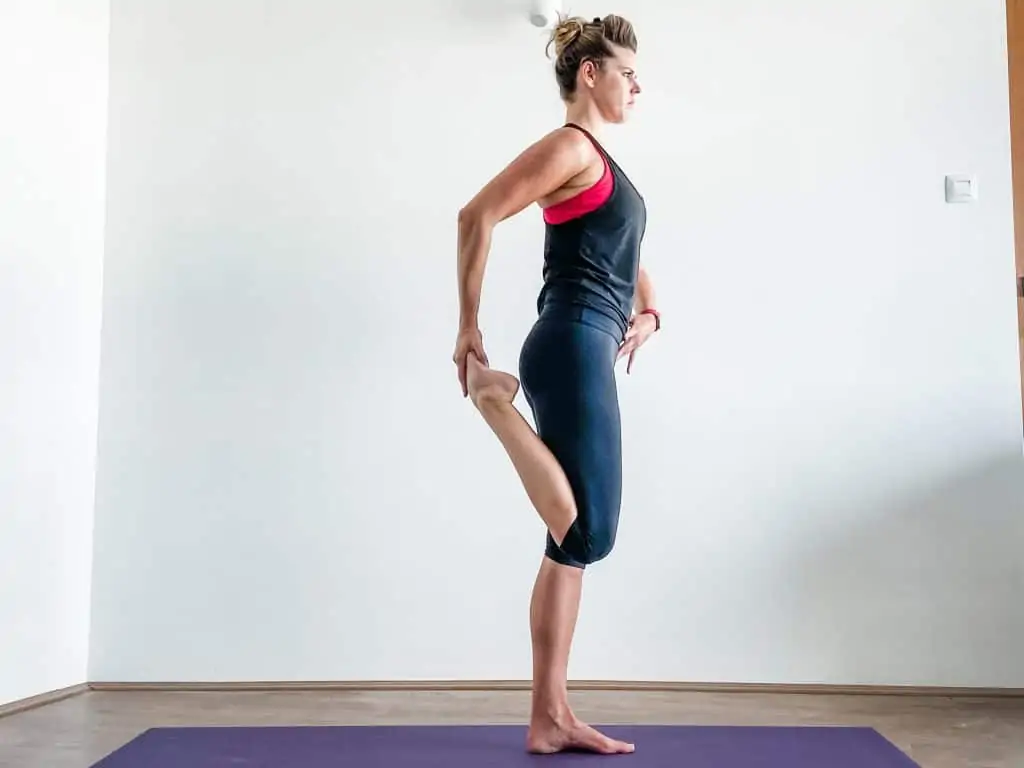 woman demonstrating a standing quad stretch