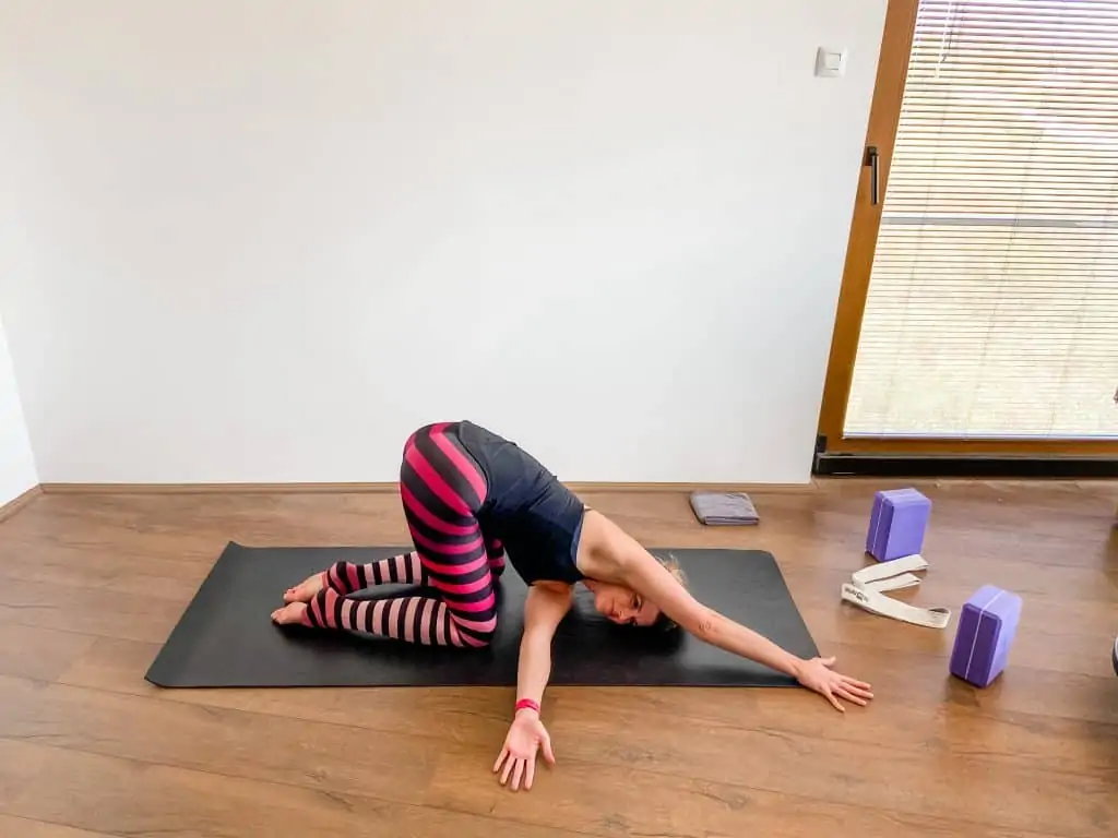 woman on a yoga mat demonstrating thread the needle pose