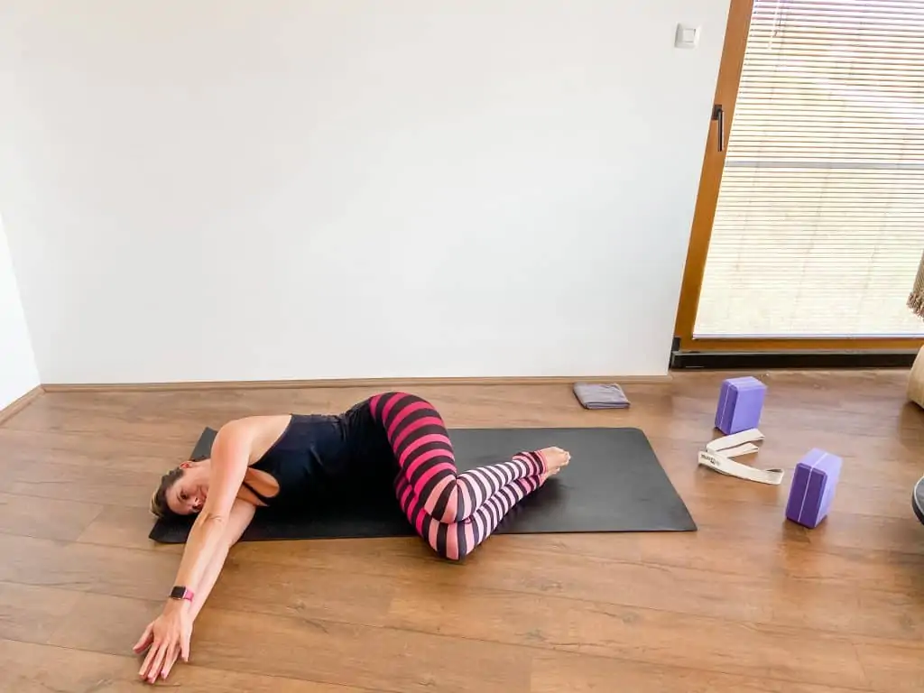 woman demonstrating a supine thoracic rotation stretch