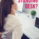 woman sitting at a desk holding her back in pain with text overlay do you need a standing desk?