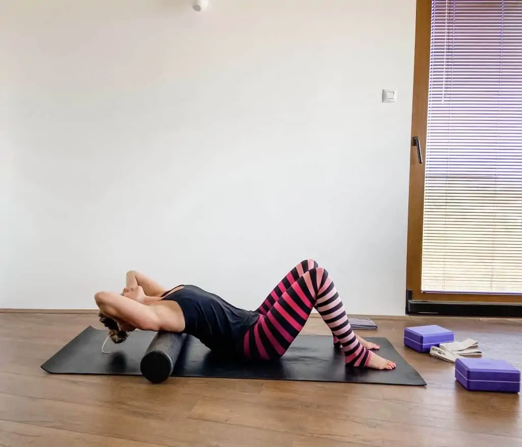 woman using a foam roller for thoracic extension - physical therapy exercises for posture