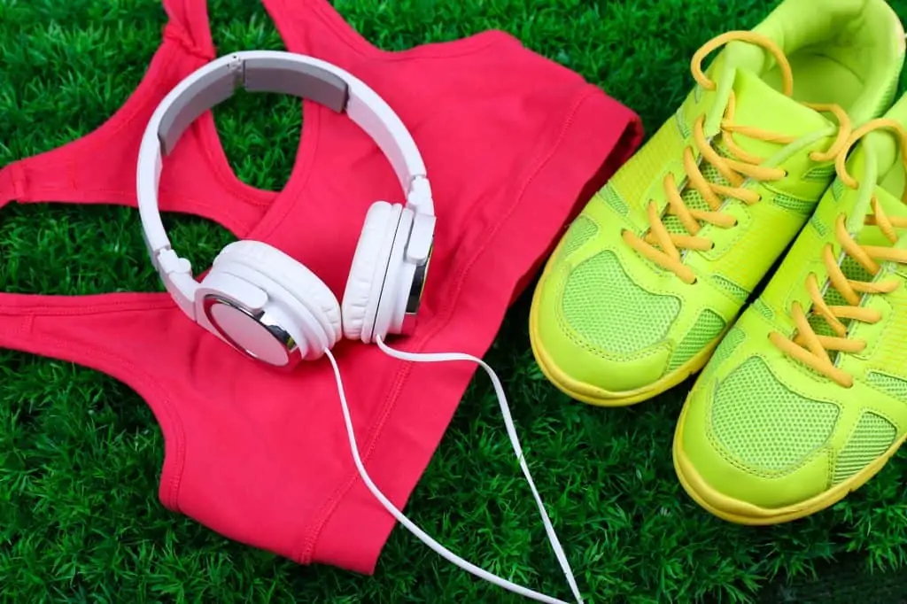 flatlay image of headphones, sneakers, and workout gear as a decorative image for an article about fitness accessories