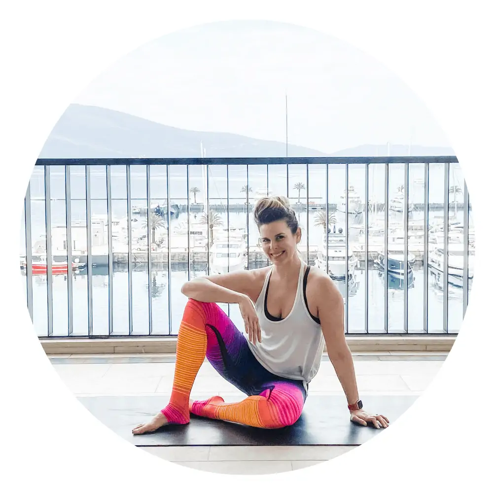 woman sitting on a yoga mat with ocean background