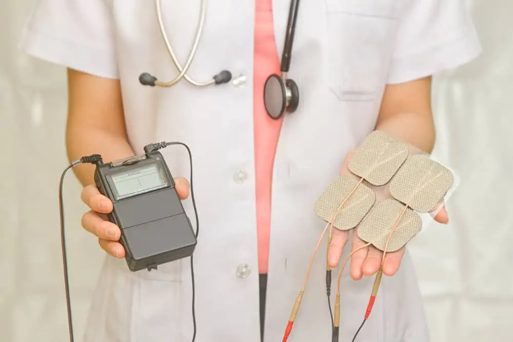 a doctor holding a tens unit as a decorative image in an article what do tens units do?