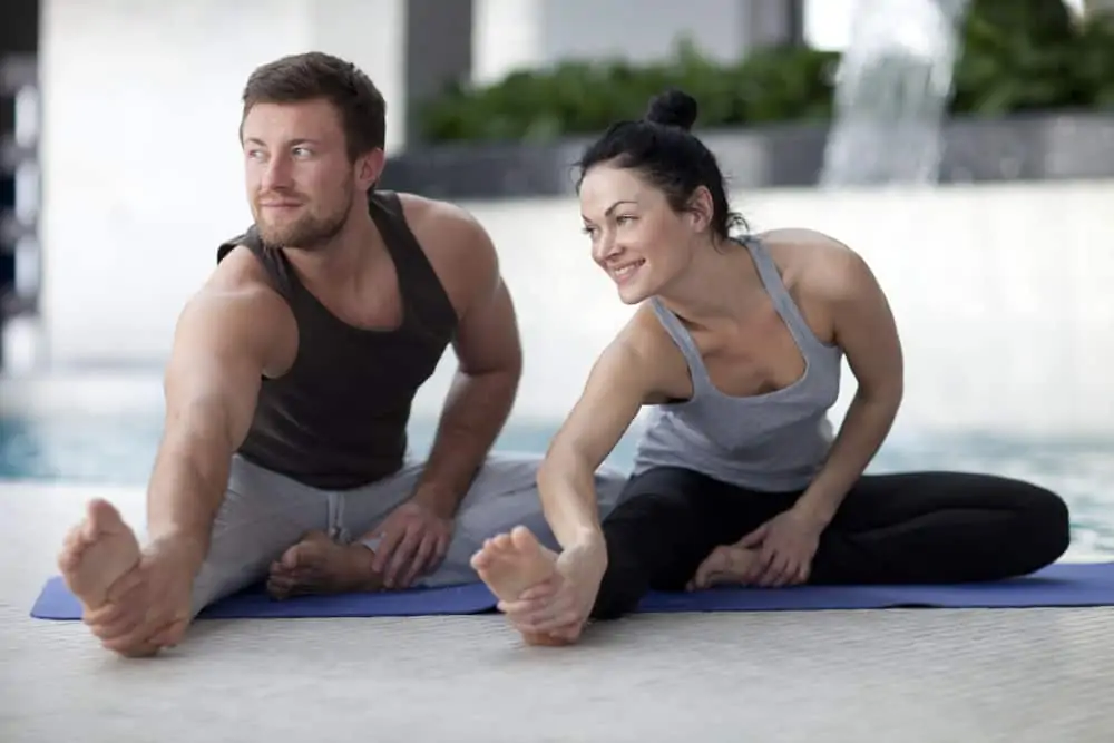 couple stretching during yoga