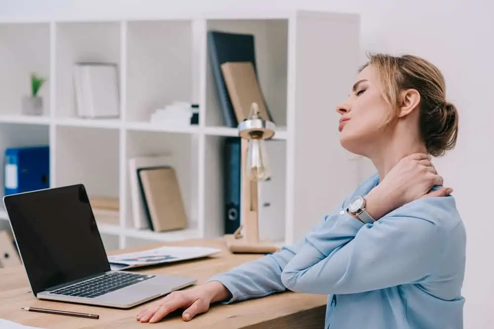 woman working at a desk with neck pain
