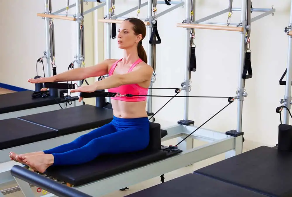 woman doing pilates on a reformer