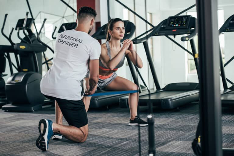 personal trainer working with a client - what is corrective exercise