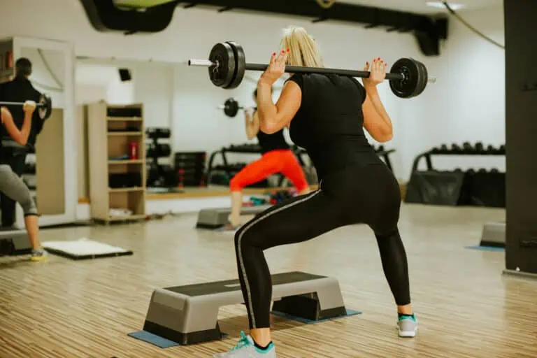 woman at a group fitness class lifting weights