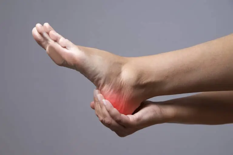 person holding a painful heel - are birkenstocks good for plantar fasciitis