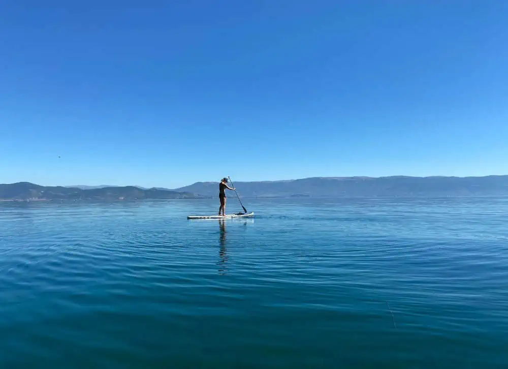 woman paddleboarding on a lake